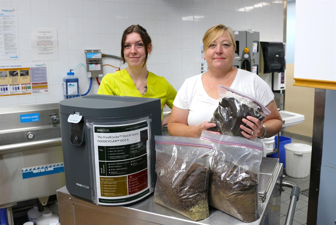 The Deep River and District Hospital (DRDH) is excited to share that we are fighting food waste by participating in the Town of Deep River’s FoodCycler Food Waste Diversion Pilot Program. As part of this environmental stewardship initiative, three FoodCycler units arrived at DRDH earlier this summer and are already being used to turn our spoil into soil! FoodCyclers are electric composting units that take food waste and turn it into a nutrient rich soil amendment that can be used as a fertilizer – referred to as ‘Foodilizer’. FoodCyclers claim they can reduce food waste volume by up to 90%, and only consume 0.8-1.5 kHh per cycle, which is equivalent to having a desktop computer running for the same amount of time as the cycle. Food waste is being collected from across the organization to be turned into compost. The compost, or ‘Foodilizer’, from the FoodCycler units will be used onsite at DRDH to support sustainability by bringing our food waste out of the garbage and into the garden. By participating in this program, DRDH is not only reducing our impact on the environment, but we are also helping to test the viability of onsite food waste processing technology as a method of waste diversion. Data is being collected by our Dietary team over a 12-week period, and it will be shared back with the Town of Deep River once the pilot program is completed. We look forward to sharing more information about the impacts of this environmental stewardship initiative in the coming months.
